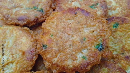 Close-up of Golden Brown Patties with Green Herbs
