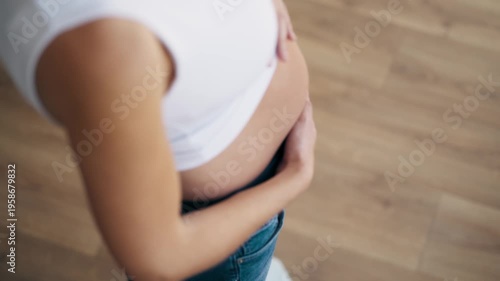 Video of pregnant woman weighing herself on a digital scale at home