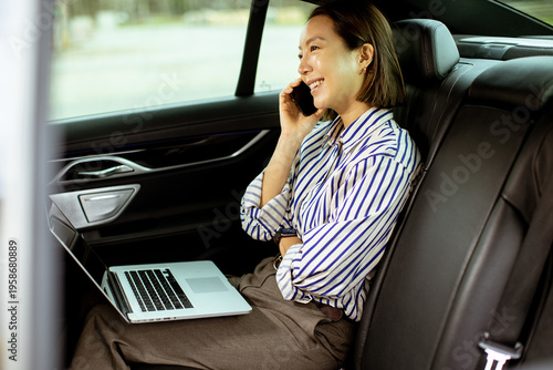 Korean woman sits in car, t...