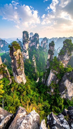 Towering karst peaks rise amidst lush greenery under a cloudy blue and golden sky