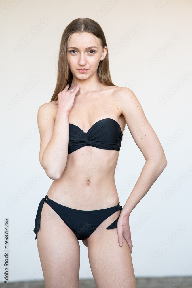 Obraz premium Portrait of smiling young woman with natural makeup looking at camera. Clean beauty model agency test shot with soft light, minimal style, fresh skin, neutral background, authentic face expression