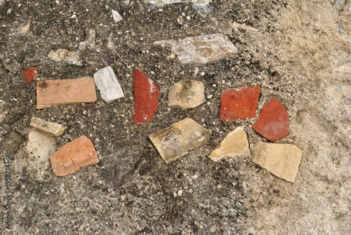 Rough Textured Stones and Brick in Cement Wall in Close Up 