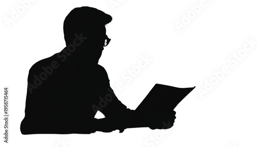 Dark silhouette of a person in formal attire reading documents while seated at a bright, empty surface.
