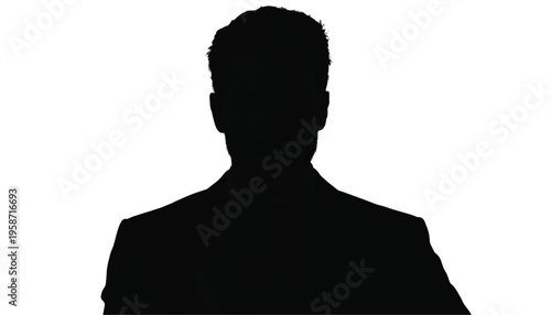 Silhouette portrait of a sharply dressed male executive shows a serious expression against a stark white.