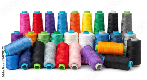 Colorful sewing threads on spools arranged neatly on a white background for crafting and fashion design