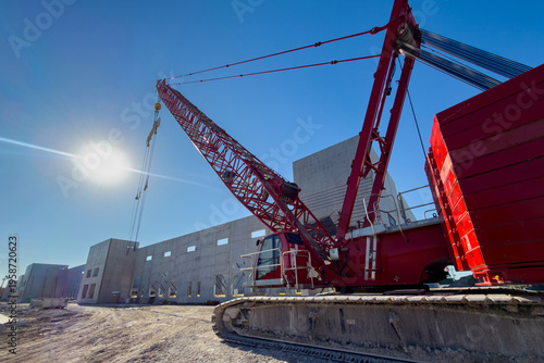 Fotografie Heavy duty high-capacity lattice-boom crawler, crane parked at warehouse constru
