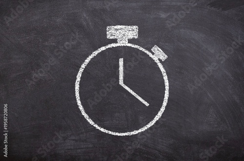 A chalkboard with a clock drawn on it