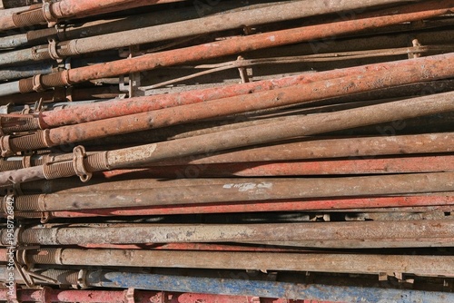 Rusty metal scaffolding pipes stacked, industrial texture background