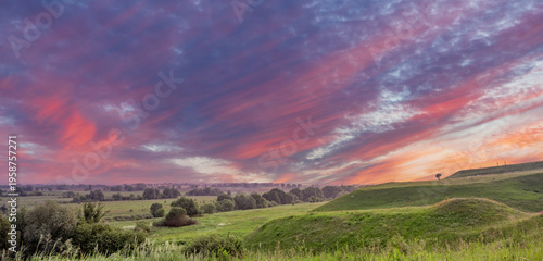 Wallpaper Mural Dramatic sky colors over serene grassy fields at golden hour Torontodigital.ca