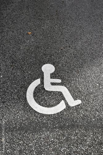 Disabled parking sign on asphalt