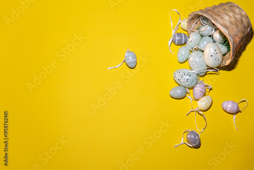 Easter eggs in a basket to celebrate Easter on a yellow background.