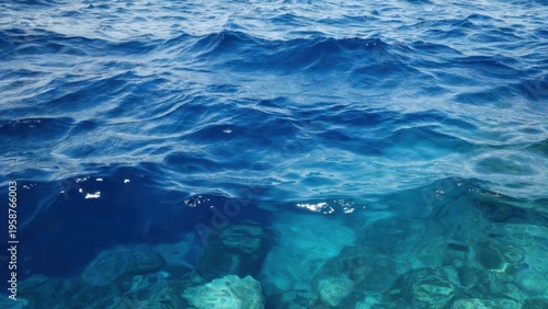 Clear blue sea with visible rocky seabed beneath surface