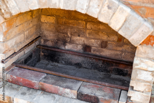Interior view of a brick barbecue oven showing grilling surface