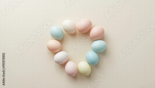 Pastel colored eggs arranged in heart shape on beige background  