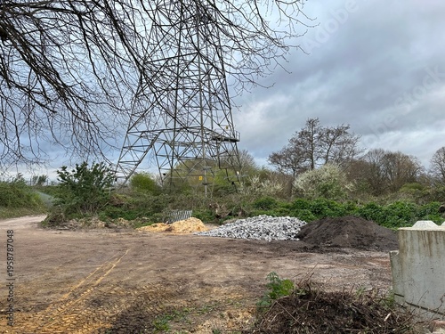 industrial scene with rubble, sand, building materials and electric pylon
