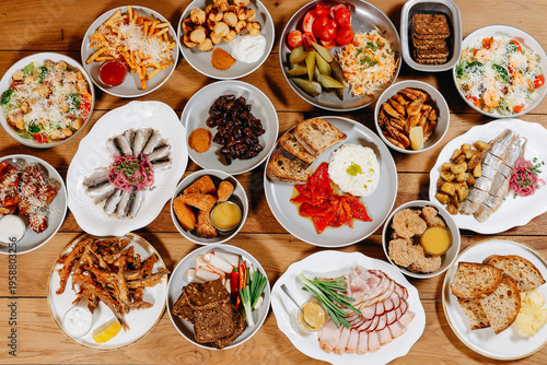 Appetizer and tapas table spread for casual party with bread, salads and seafood