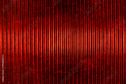 Closeup of old car tail light lens with red glowing vertical ridges and scratches, abstract automotive texture for background design, retro transport and industrial concepts