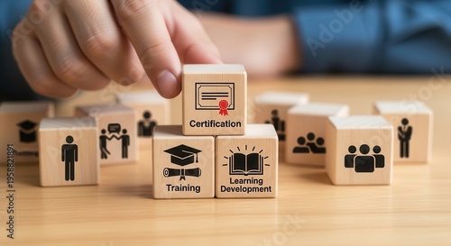 Training and Learning Development. Wooden blocks with human icons, placing a certification block on top, symbolizing structured training, skills development and organized learning pathways