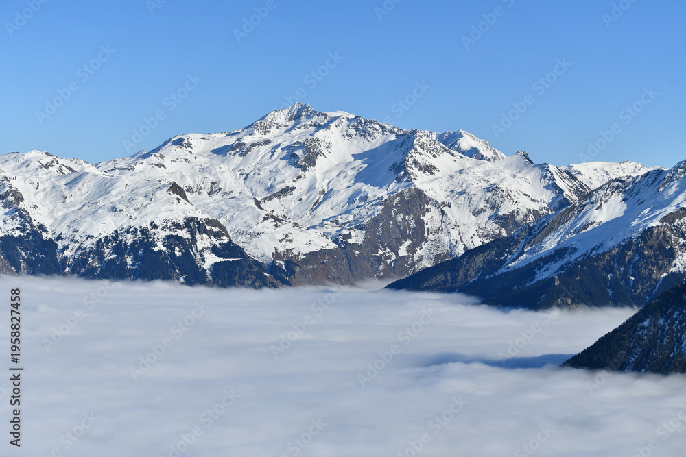 Obraz premium Snowcapped French alps under sea of clouds by winter