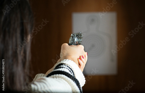 Female markswoman concentrating during target practice