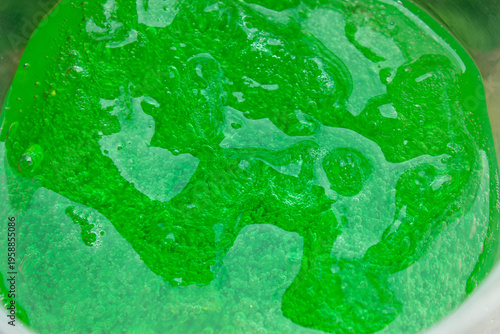 Картината върху платно thick green gel soap with bubbles in it