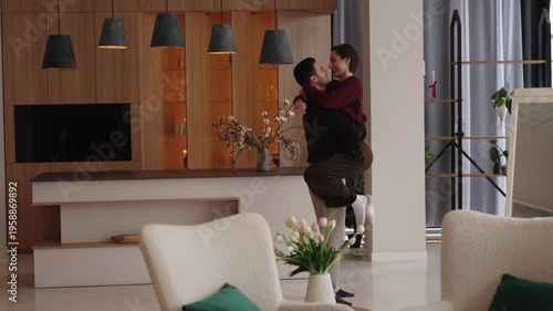 Couple dancing in modern living room with stylish decor and bright ambiance