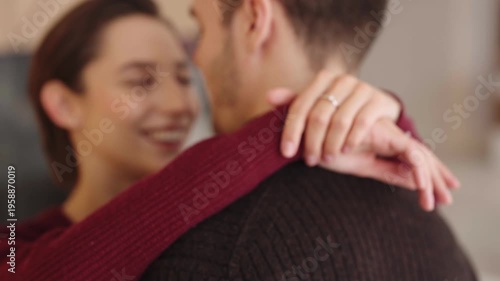 Couple embraces each other and shows their engagement rings