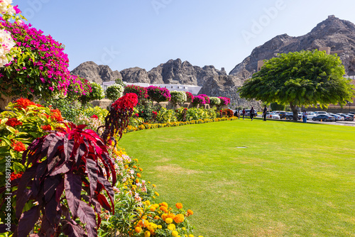 Muscat, Oman – December 28, 2025: Green garden and open plaza area in front of Al Alam Palace, the official palace of the Sultan of Oman, located in the historic district of Muscat and surrounded by r