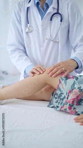 Doctor and kid patient. Orthopedist examining girl's knee in medical clinic. Medicine and health care