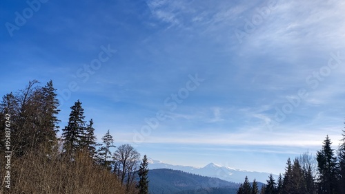 Scenic mountain panorama with blue sky and clouds background