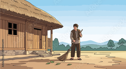 A man in traditional attire diligently sweeps the yard outside his rustic thatched-roof home in a peaceful village setting.