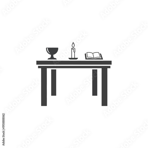 A table with a chalice, a lit candle, and an open book, suggesting a spiritual or religious setting, perhaps for prayer or study