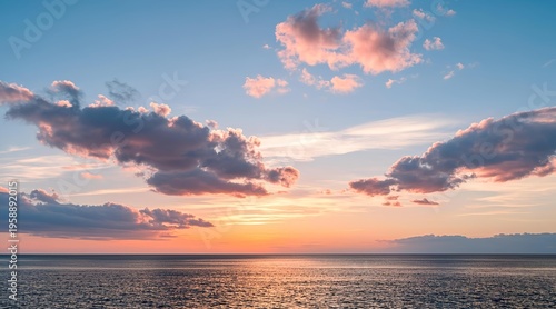 Beautiful Sunset Sky Over Calm Ocean Water with Colorful Clouds Reflecting Golden Light at Dusk