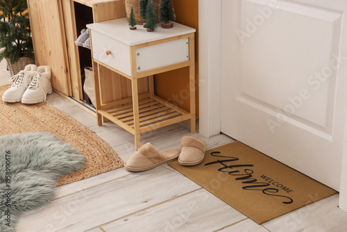 Slippers with rugs near doo...