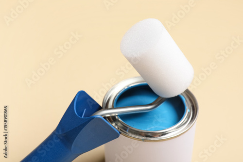 Can of paint with roller on...
