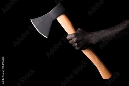 Hand in black paint holding...