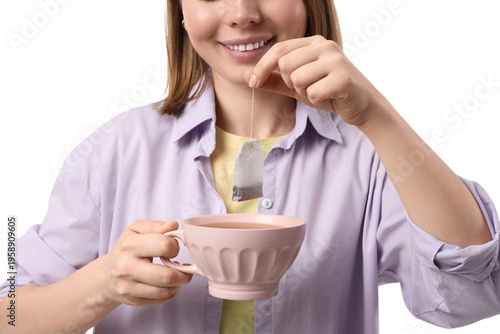 Young woman dipping tea bag...