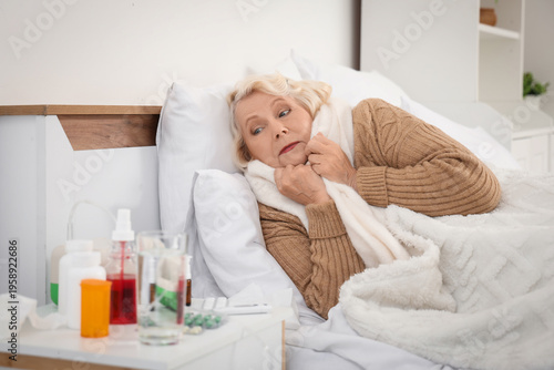 Sick elderly woman with med...