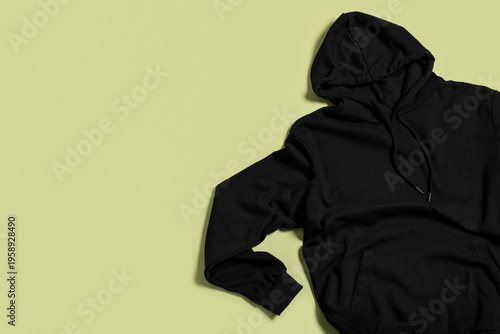Black hoodie on green backg...