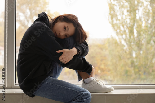 Depressed young Asian woman...
