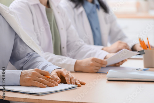 Doctors with notebooks work...