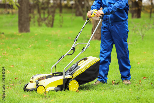 Young male gardener trimmin...