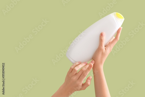 Female hands with bottle of...