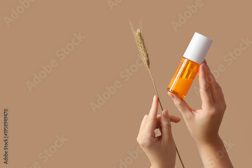 Female hands with bottle of...