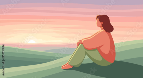 Woman sitting on a hill watching the sunset.