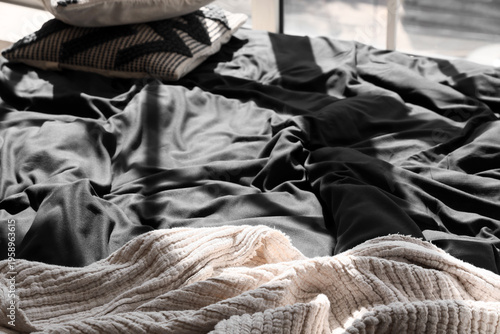 Rumpled black satin bedding...
