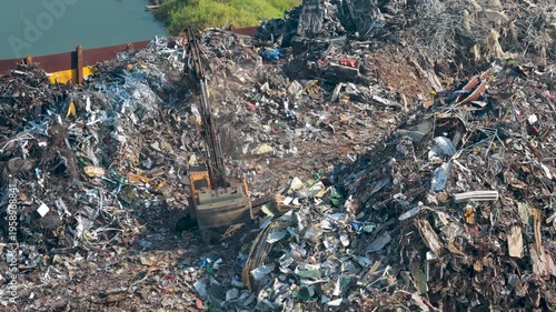 Aerial view of bustling recycling plant shows waste being sorted with automated machinery and heavy equipment