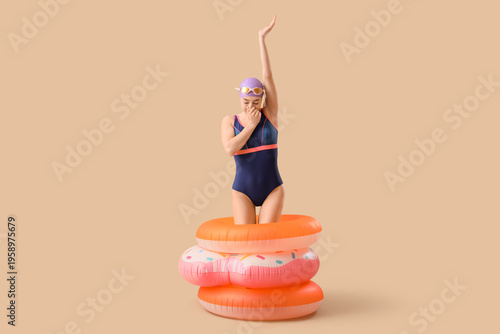 Young female swimmer with i...
