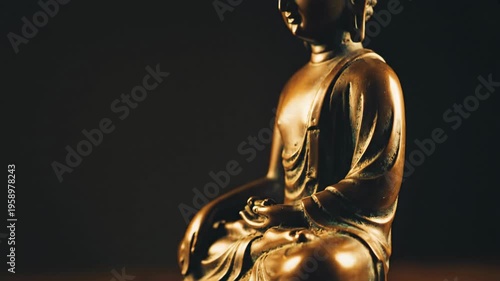 Close up of a bronze Buddha statue seated in meditation on a lotus flower base, with a dark, moody background, conveying peace and spirituality