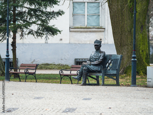 Fényképezés Solitary figure sits pensively on a park bench